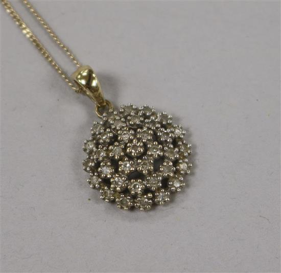 A 9ct gold and diamond set cluster pendant on a 9ct gold chain, pendant 15mm.